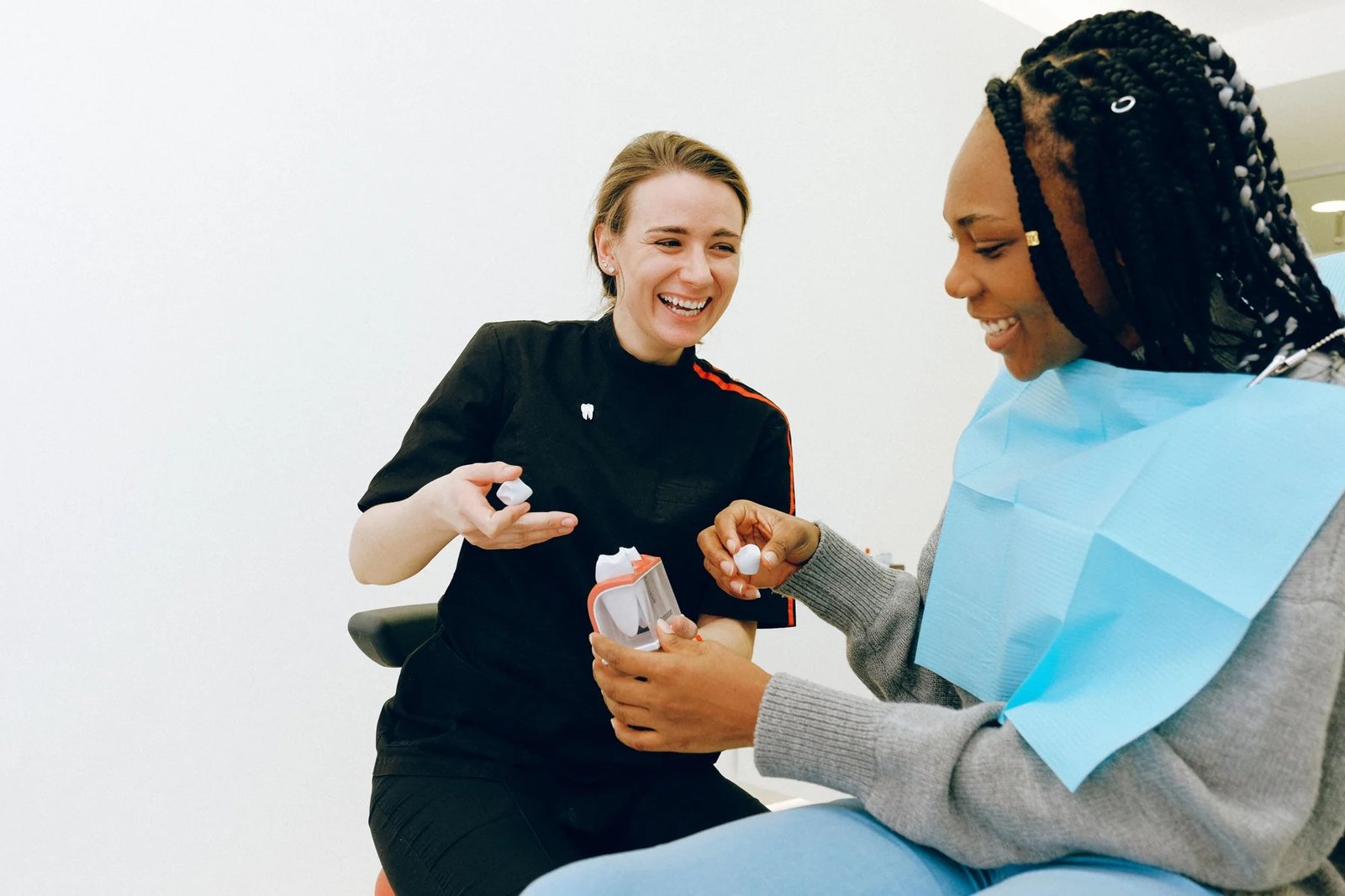 Illustrative clinician and patient discussing dental care